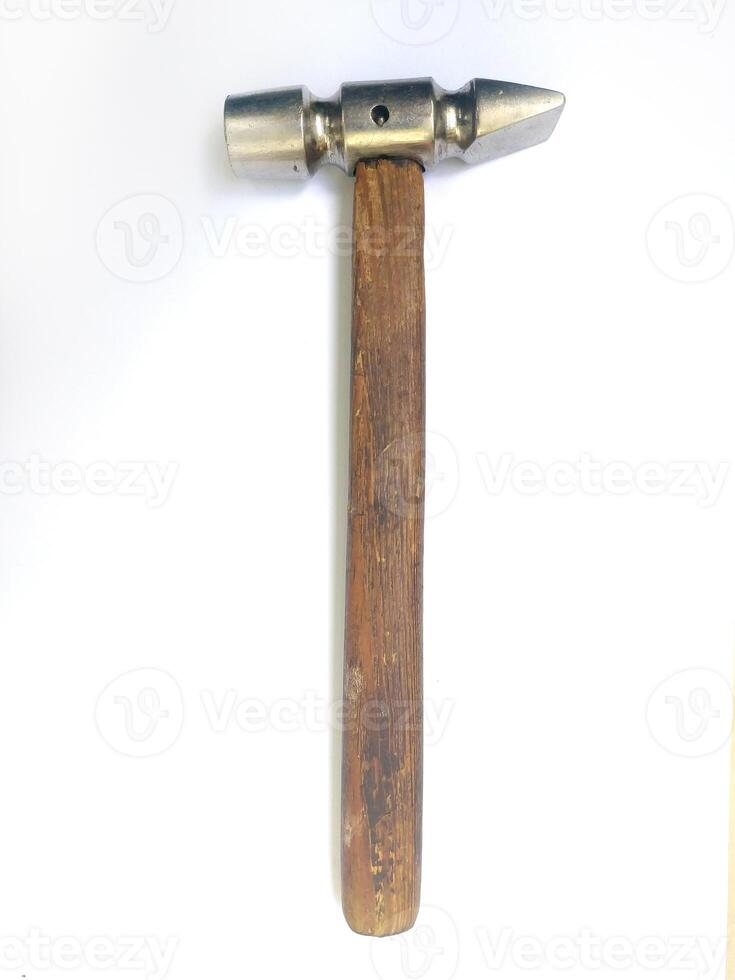 A meticulously detailed closeup showcases a vintage hammer with a worn wooden handle and a metallic head. The image evokes a sense of craftsmanship and timeless utility. photo