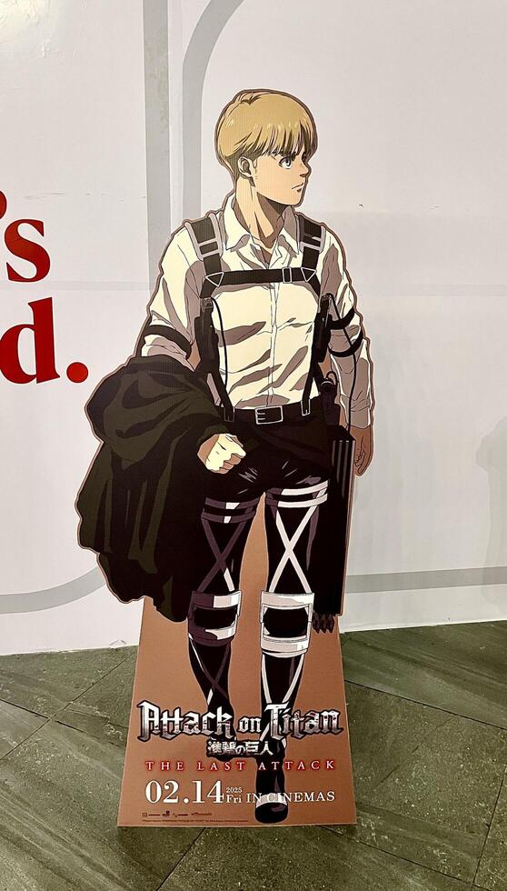 Jakarta, Indonesia - February 17th, 2025 - Attack on Titan the last attack anime movie Armin standee cut out cardboard display on vertical indoor environment background. photo
