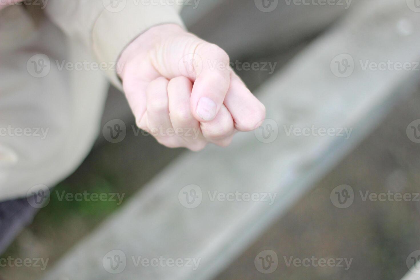 Female hand clenched into a fist. photo