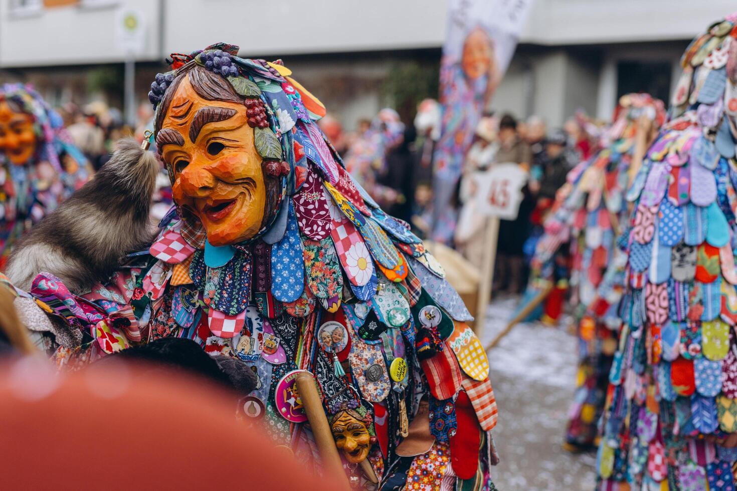 Schwabisch Gmund,GERMANY-FEBRUARY 13,2024.Spring carnival with people in various costumes, surrounded by, a lively crowd and festive atmosphere photo