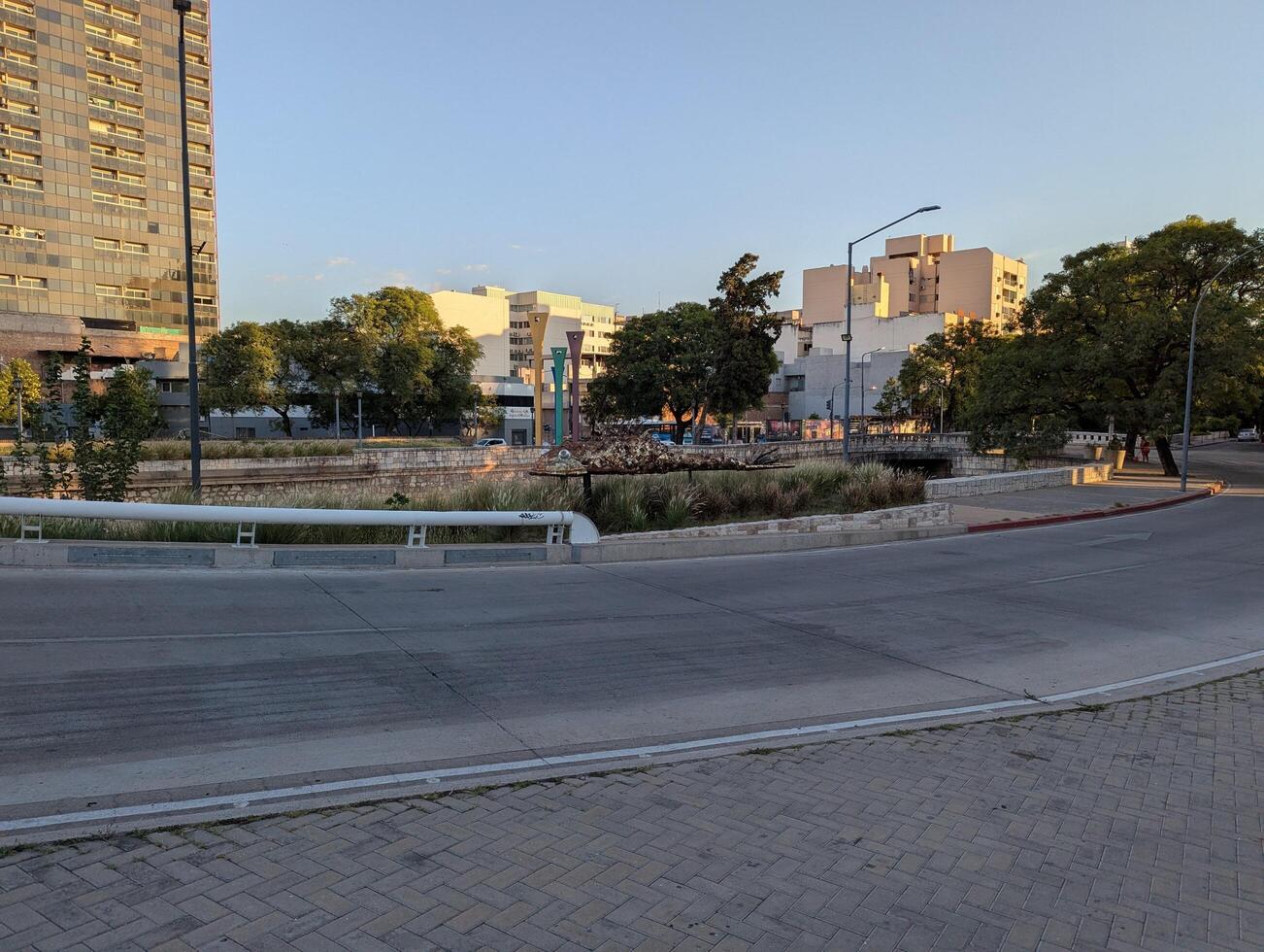 Cordoba, Argentina - 03.02.2025 Bridge and metal fish sculpture in the city center in the setting sun photo