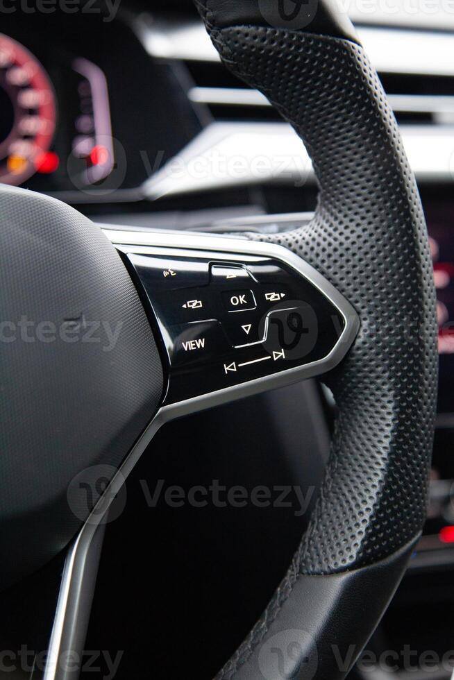 Buttons on the modern multifunctional steering wheel for controlling music and multimedia photo