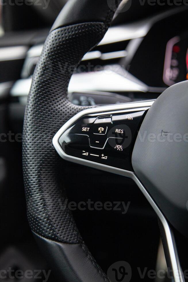 Buttons on the modern multifunctional steering wheel for controlling cruise control, lane keeping and distronic photo