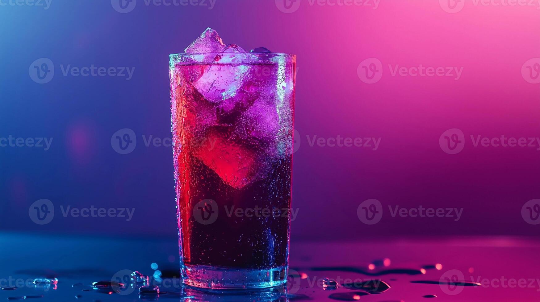 A glass of a purple drink with ice in it. The drink is on a table with a purple background photo