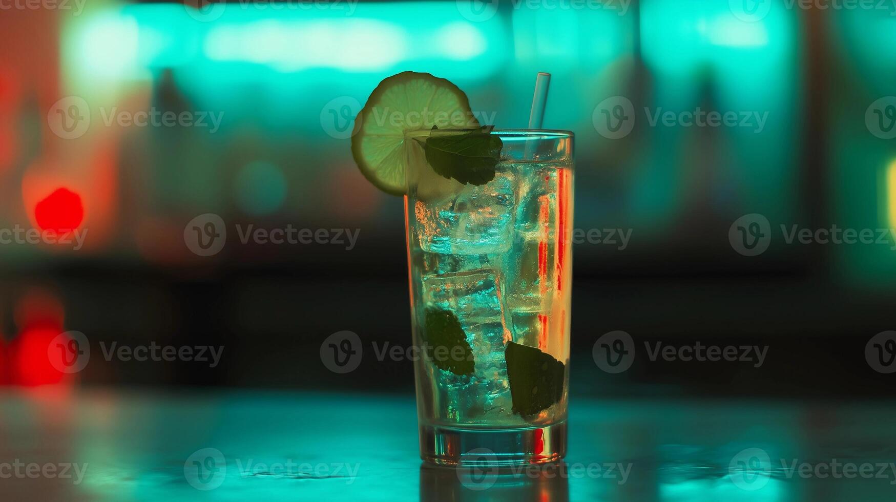 A glass of cocktail with a lime wedge on top. The drink is served on a table in a bar photo