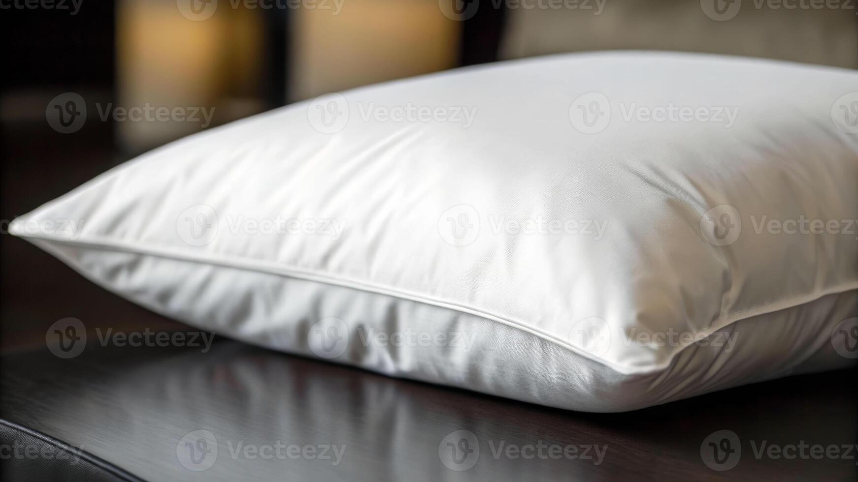 Gentle close-up of a pristine white pillow resting in a cozy bedroom environment photo