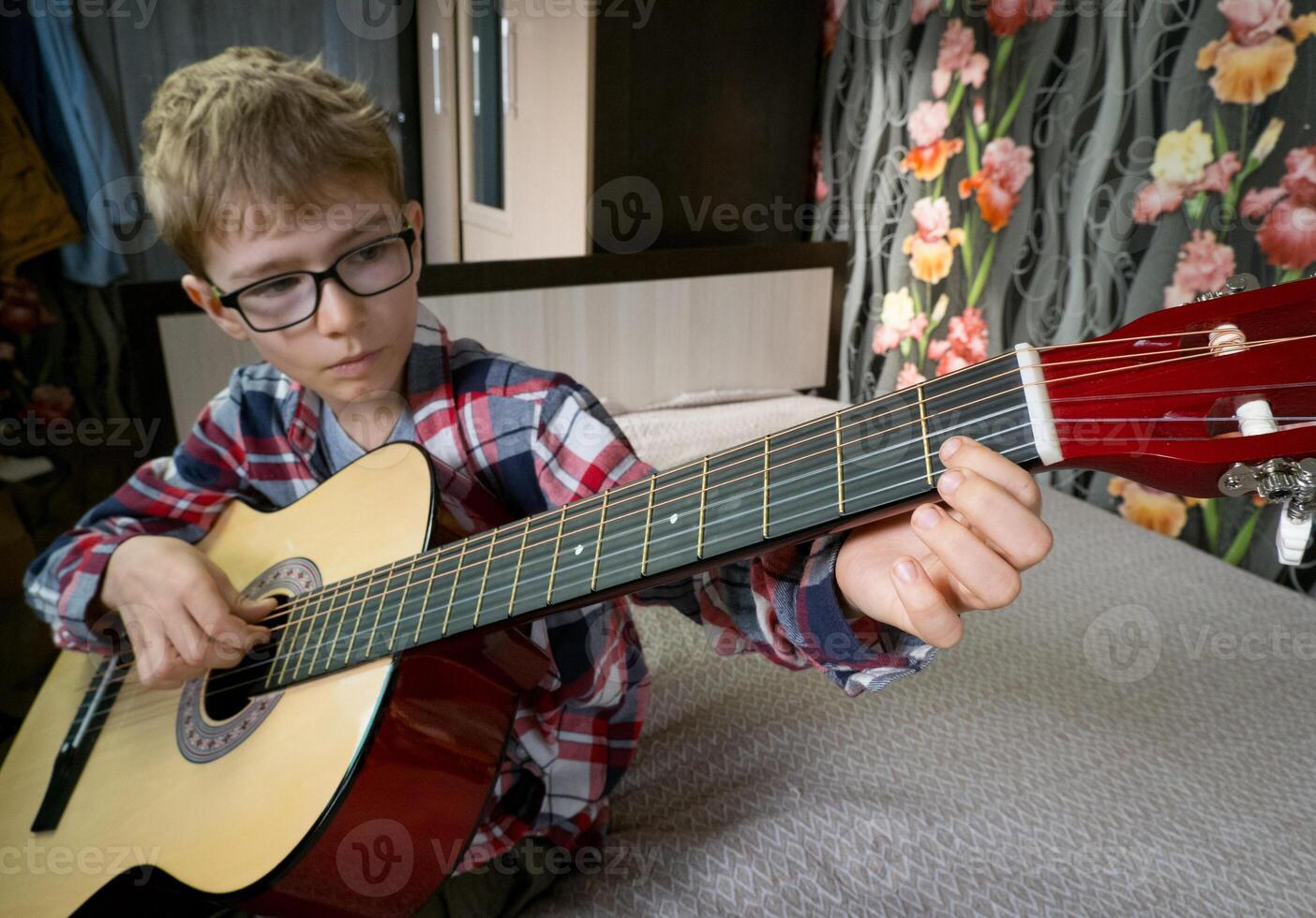 Learning to play the guitar. Music education and extra-curricular lessons. photo