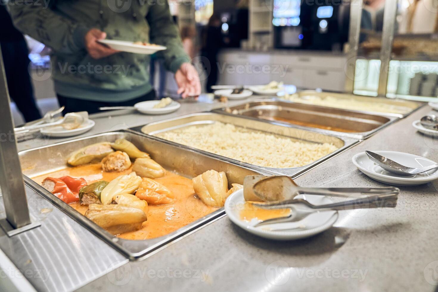 Getting hot food for the poor from volunteers. The concept of nutrition in a charity canteen. with space to copy photo