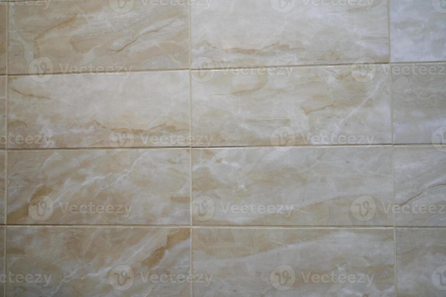 The texture of a thin beige tile. Small light waves are arranged so that they fit into the background. Beige tiles with space to copy photo