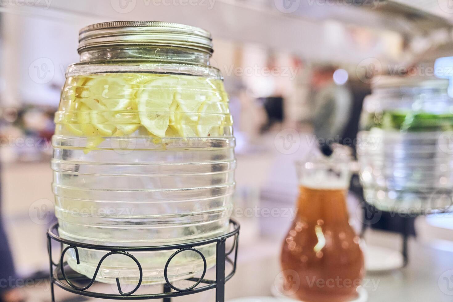 A clear pitcher of lemonade. Lemons in water. Made from a slice of lemon with a space to copy photo