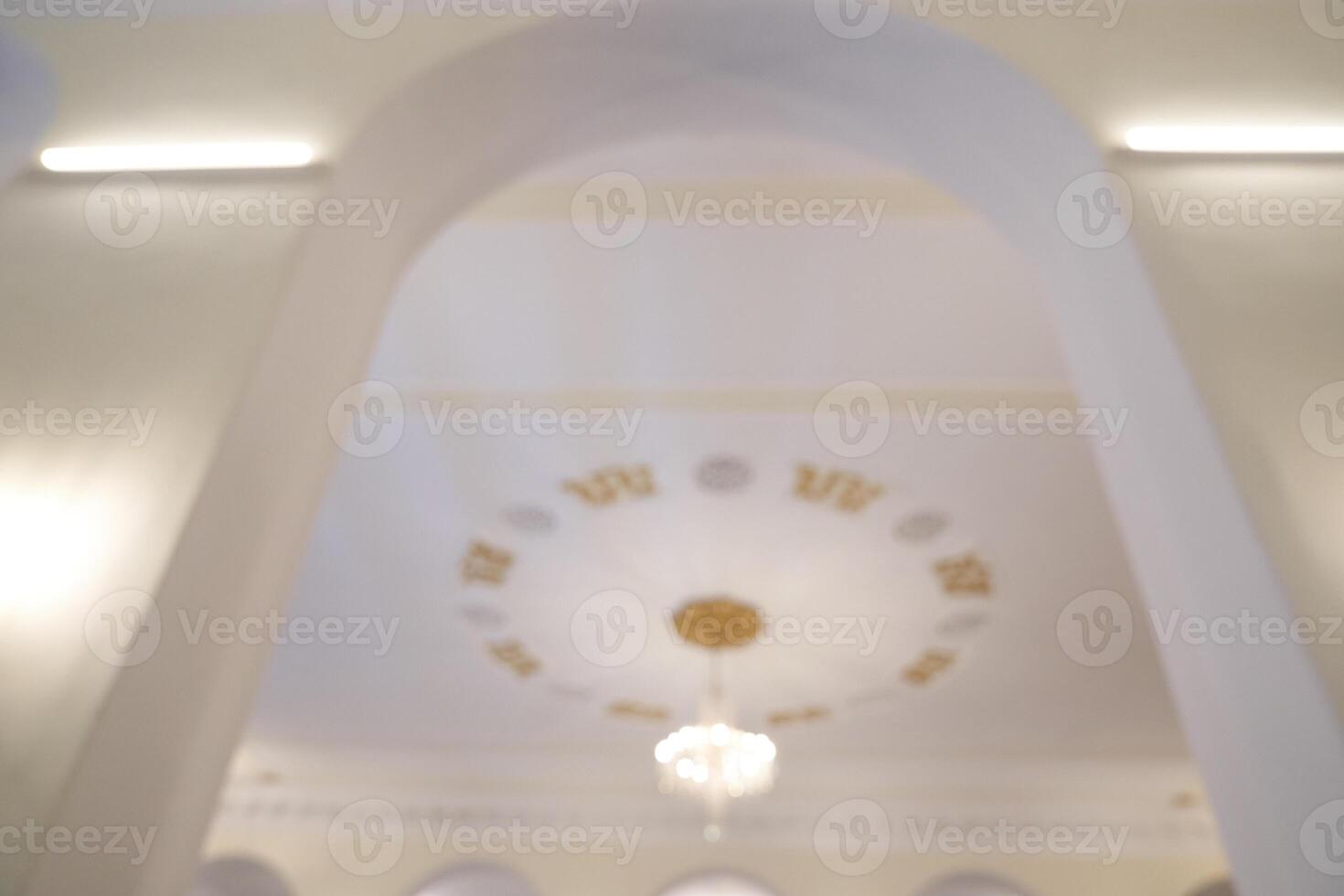 The arch has a bright and spacious ceiling with an elegant chandelier that casts warm light on the beige walls. With space to copy photo
