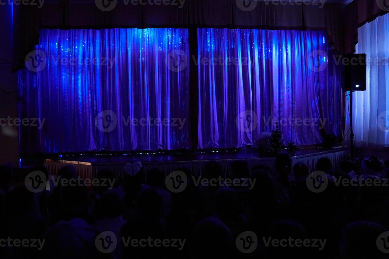 The beginning of a children's performance on stage. Cultural diversity, public art festival, children performing on stage. The theater curtains are closed photo