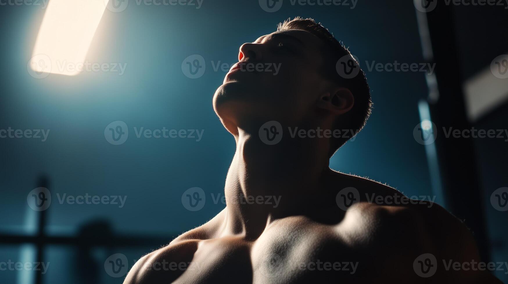 A man with no shirt on in a dark room photo