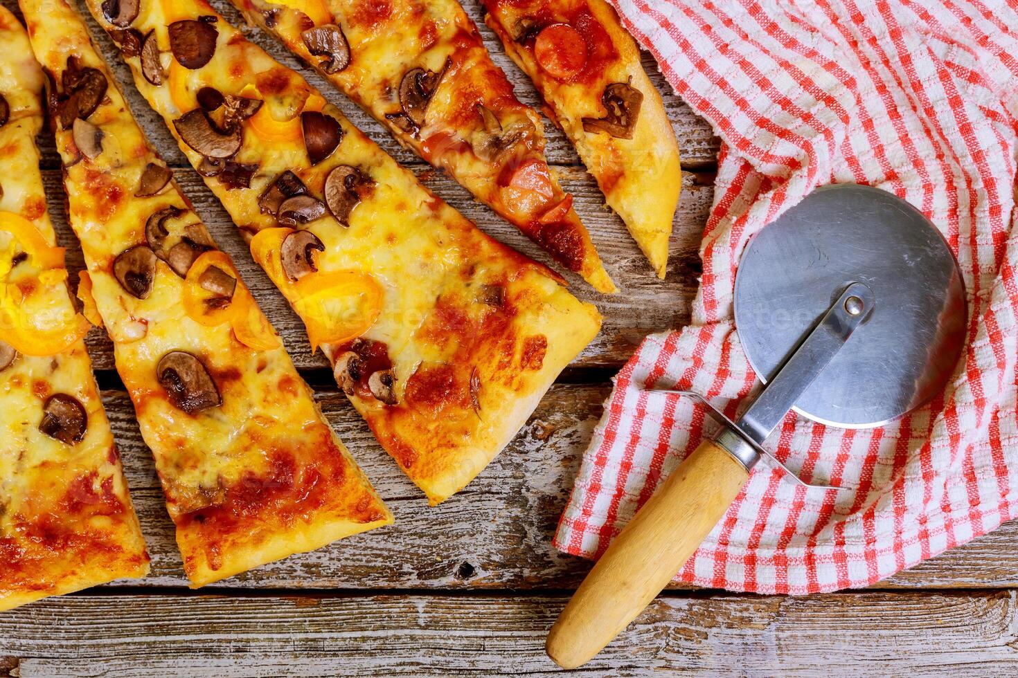 Sliced pizza on the table slices of pizza with different toppings on a wooden background photo