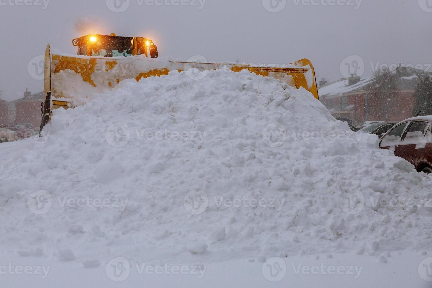 Winter. Wheel loader machine tractor removing snow. Clearing the road from ice and snow photo