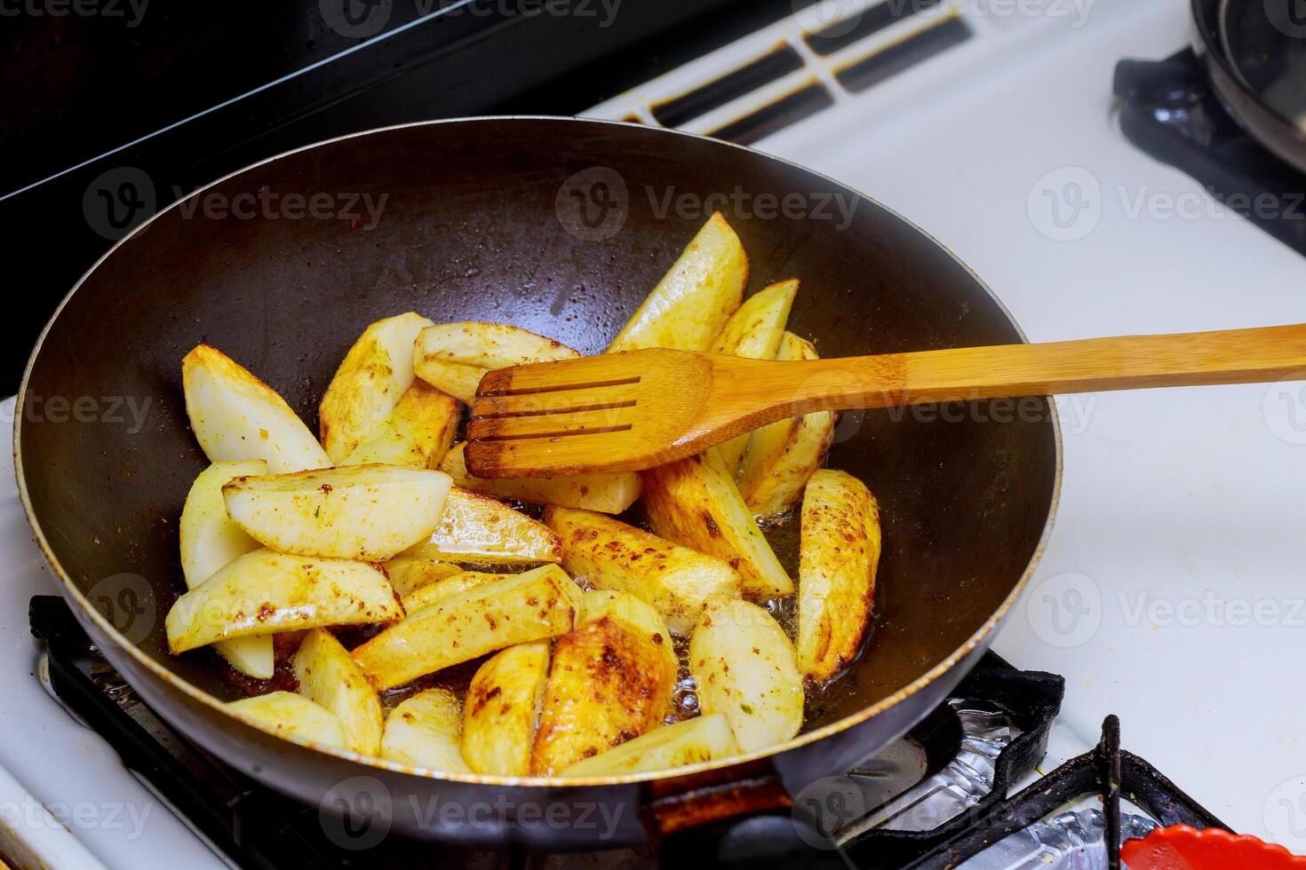 Food cooking frying pan fried potato Home made deep fried chips. photo