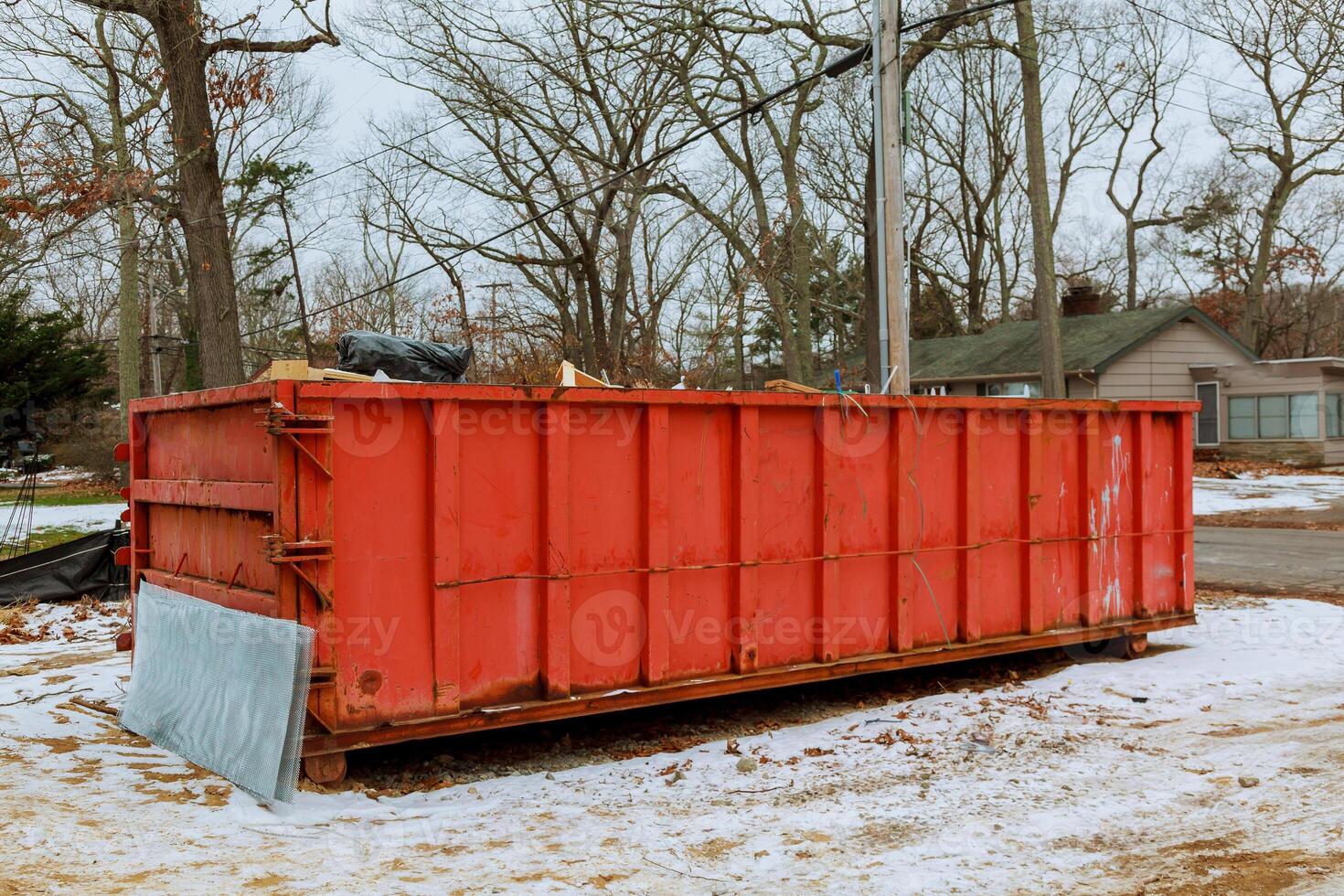 Trash bin at the side of street in winter with lip garbage container winter snow photo
