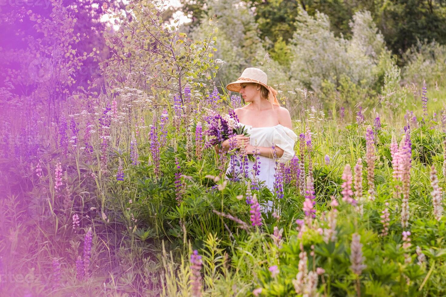 A woman in a field of purple flowers photo