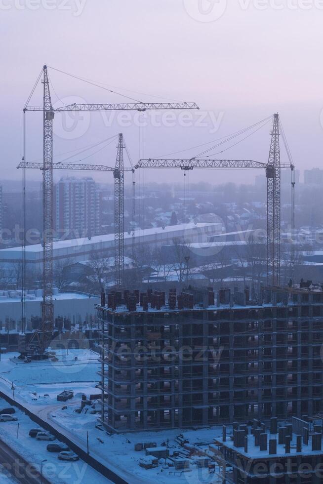 Construction cranes in the snow photo