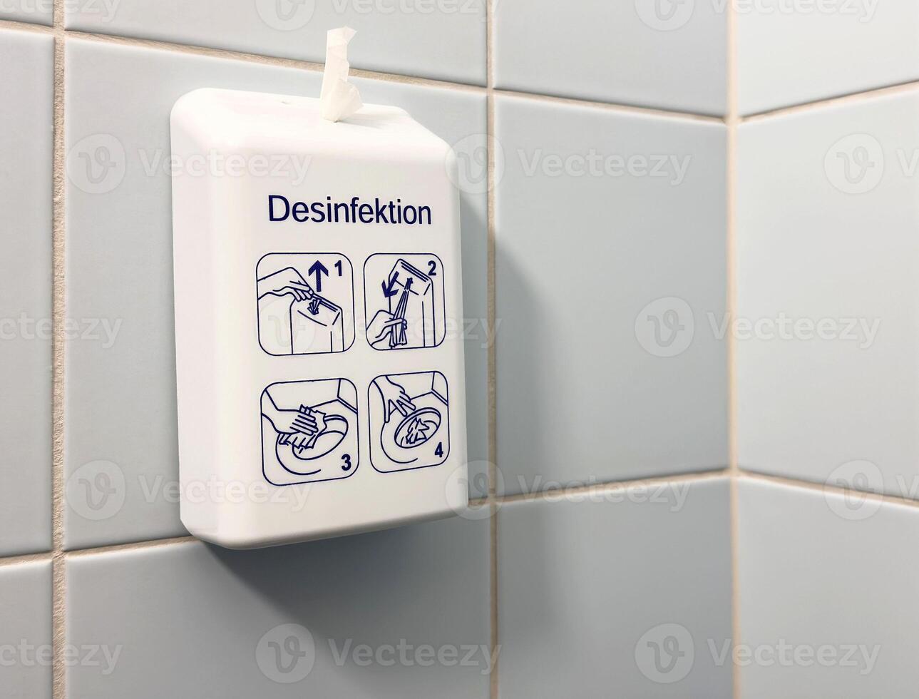 Wall-mounted hand sanitizer dispenser with instructions in public restroom photo