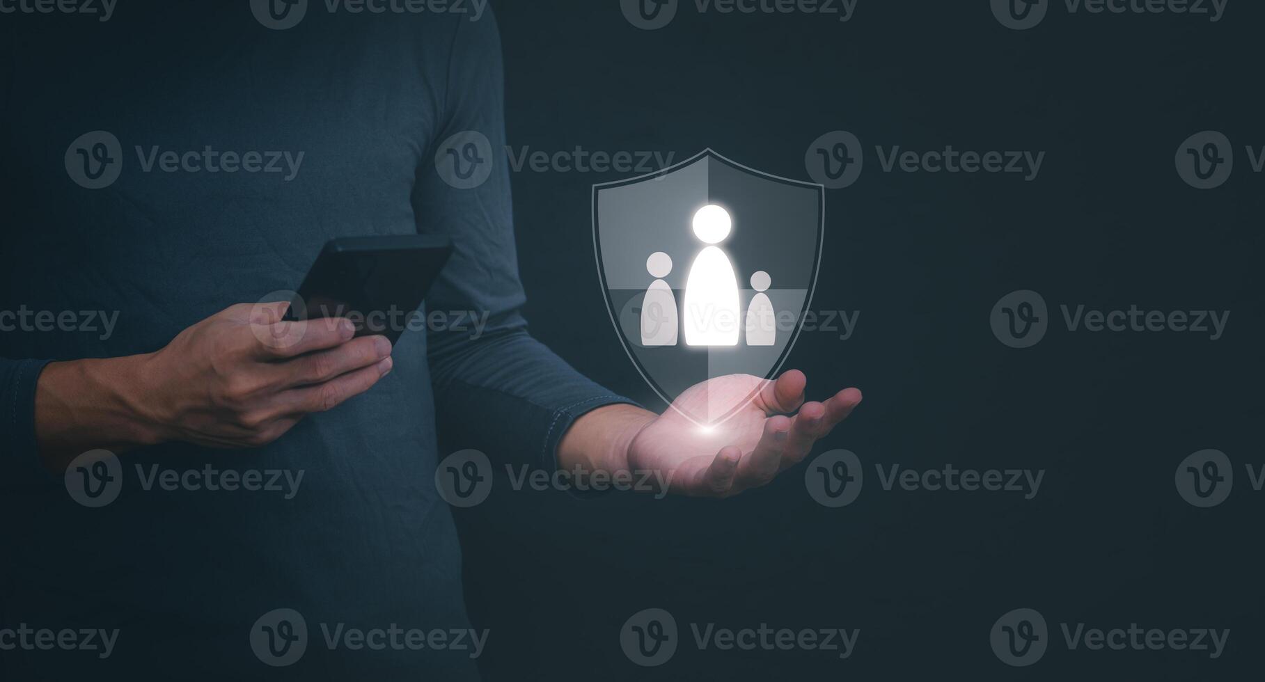 a man holding a smartphone with a shield icon on it photo