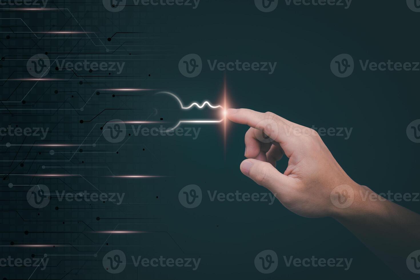 hand touching a light bulb on a circuit board photo