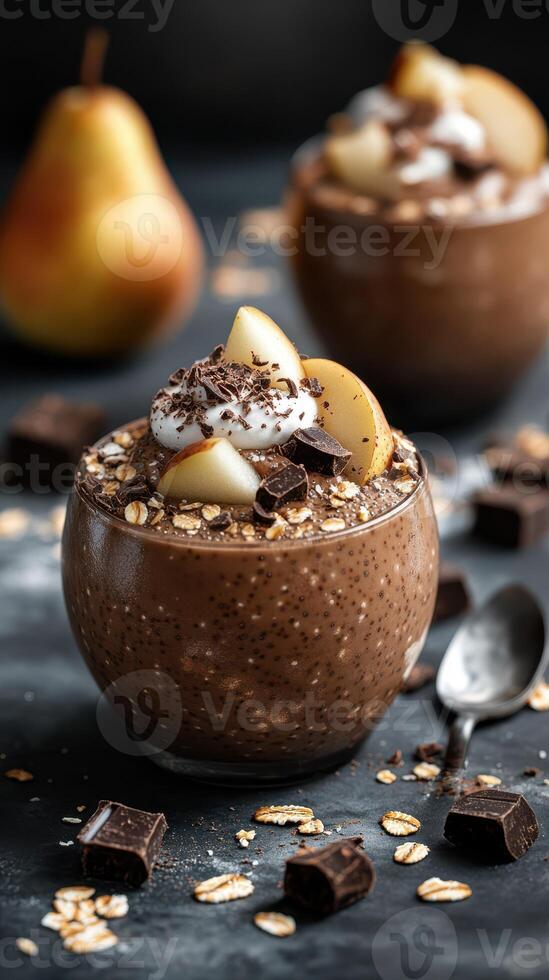 Chocolate dessert topped with fresh pears and whipped cream served in a glass bowl with chocolate pieces photo