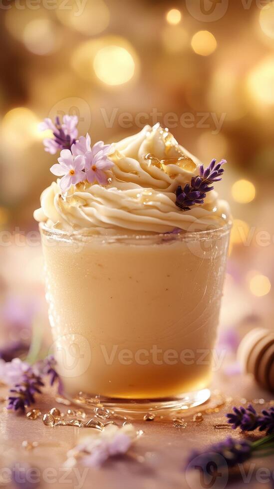 Rich vanilla cream topped with lavender flowers and golden honey in a rustic glass photo