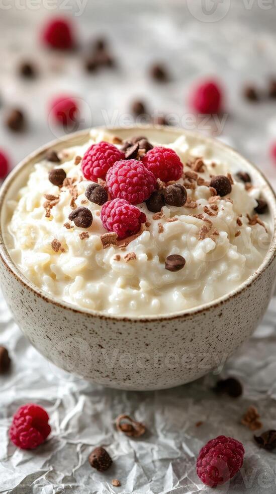 Delicious cottage cheese bowl topped with fresh raspberries and chocolate sprinkles for a healthy snack photo