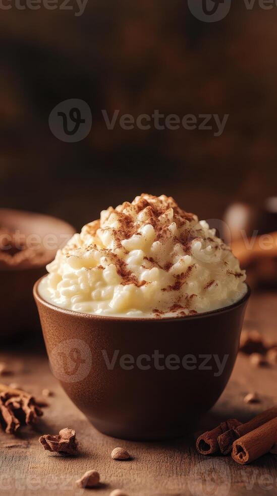 Delightful creamy dessert topped with cocoa and cinnamon served in a rustic bowl on a wooden table photo