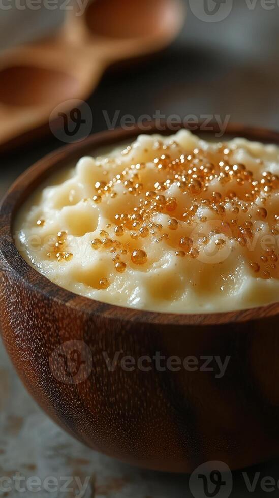 Creamy dessert topped with golden sweet pearls in a wooden bowl for a delightful culinary experience photo