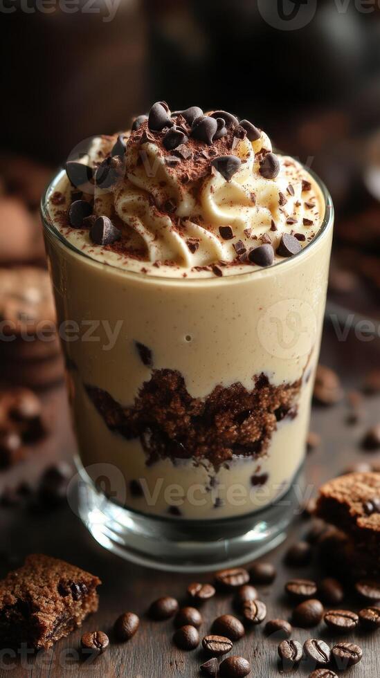 Creamy dessert with chocolate chips and coffee layered in a glass served on a wooden table photo