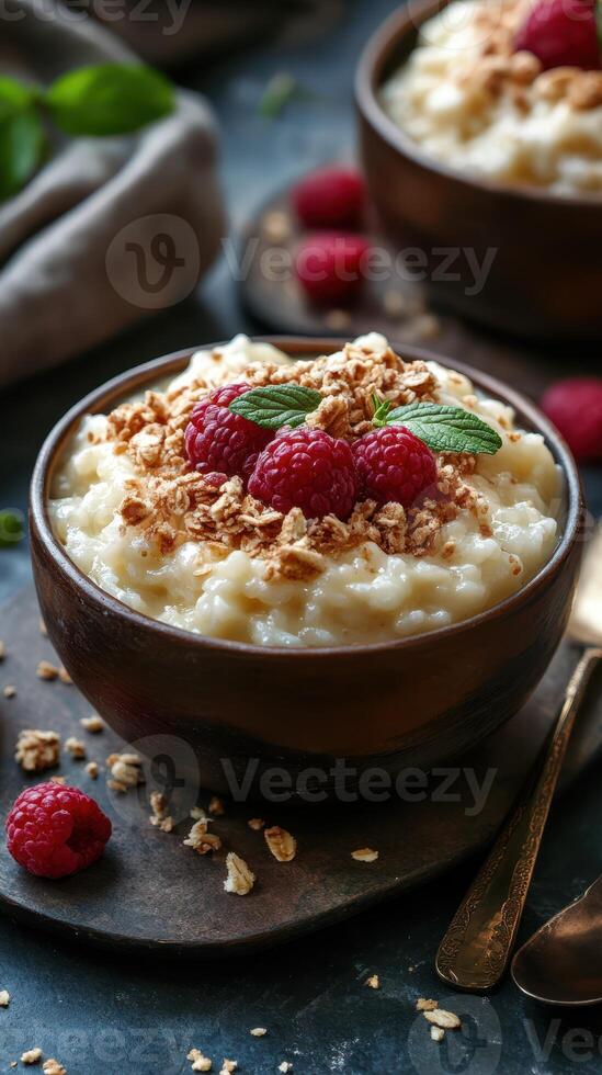 Creamy rice pudding topped with fresh raspberries and crunchy granola served in rustic bowls photo