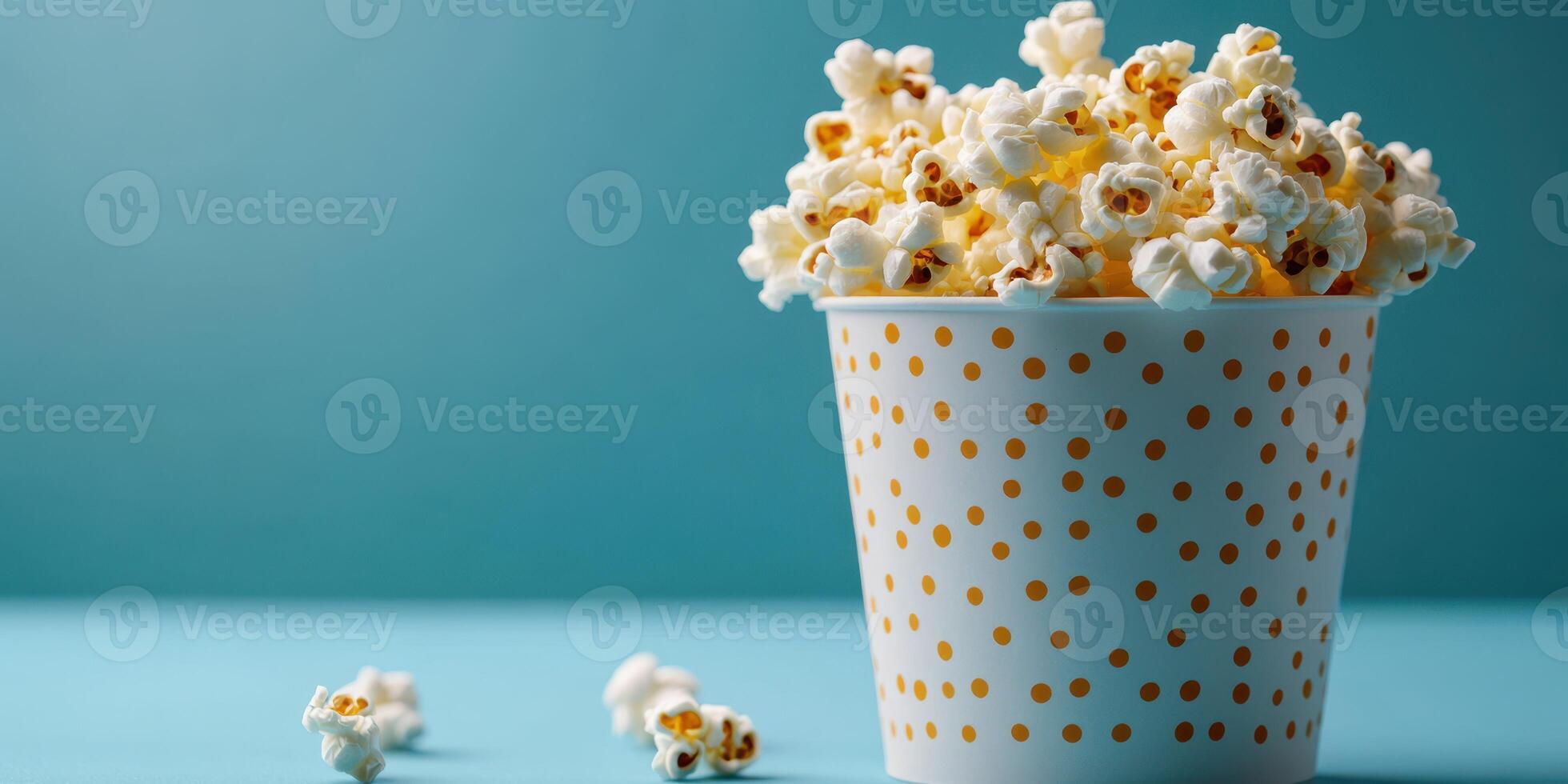 Enjoying freshly popped popcorn in a stylish cup during a cozy movie night at home photo
