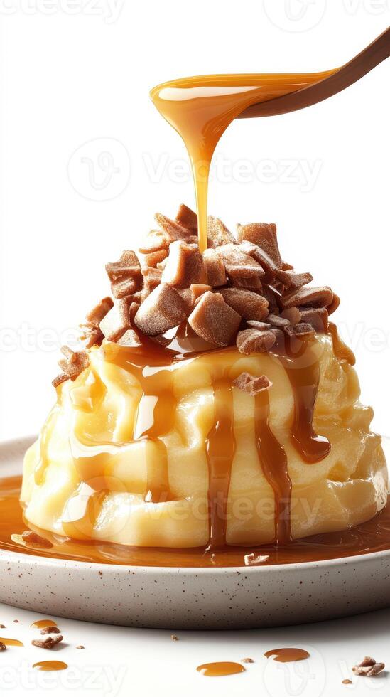 Creamy dessert topped with crunchy toffee pieces and rich caramel sauce in a simple presentation photo