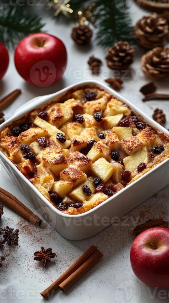 Warm apple bread pudding with raisins and spices on a festive table setting photo