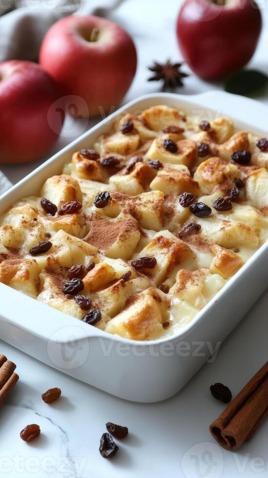 Warm apple bread pudding topped with cinnamon and raisins ready for dessert at a cozy kitchen table photo