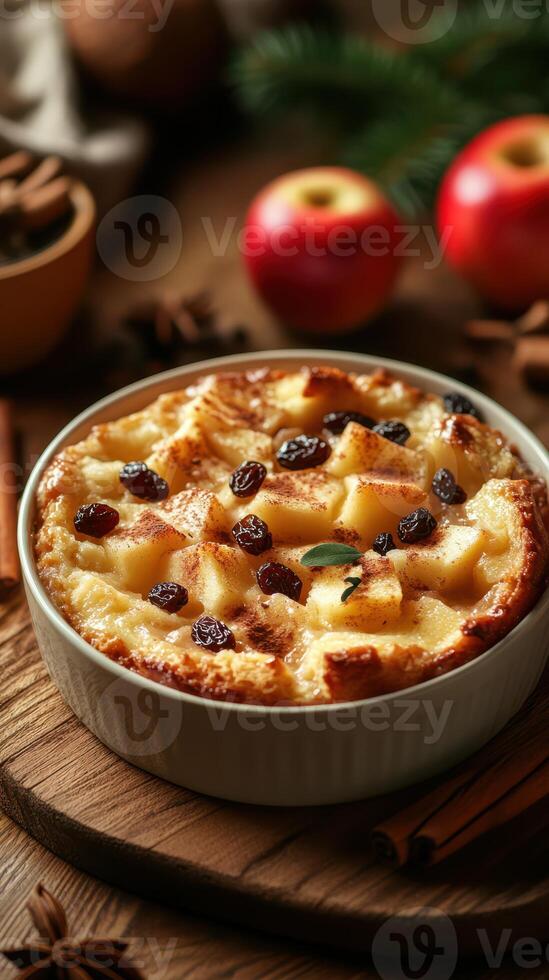 Warm bread pudding with apples and raisins served on a wooden table with festive decorations during autumn photo