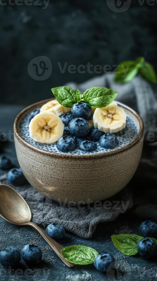 Delicious bowl of chia seed pudding topped with fresh bananas and blueberries in an elegant setting photo