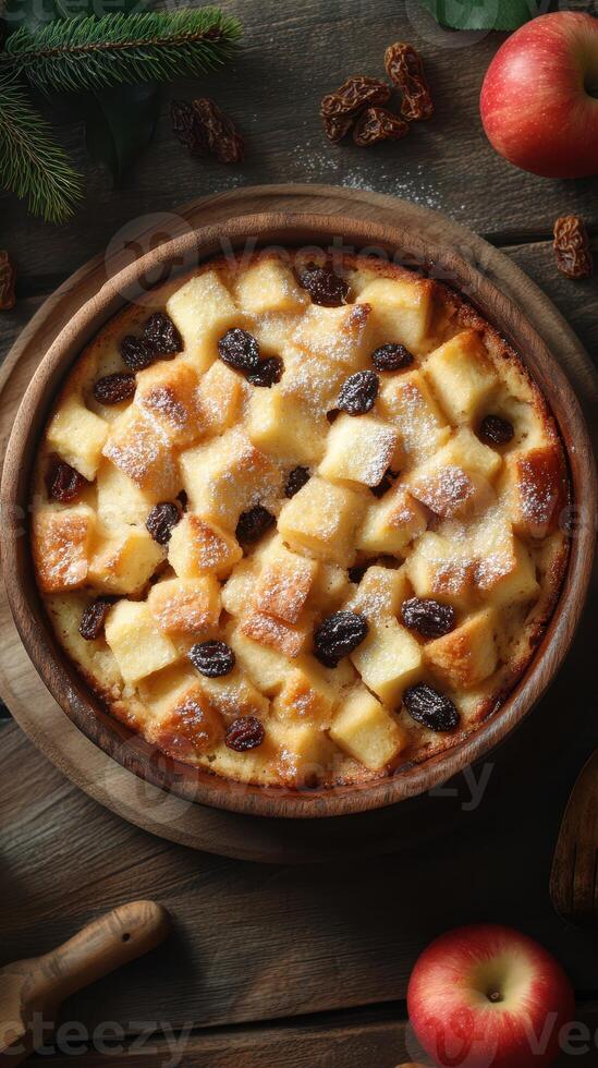 Baked dessert with bread cubes and raisins served in a wooden bowl on a rustic table photo