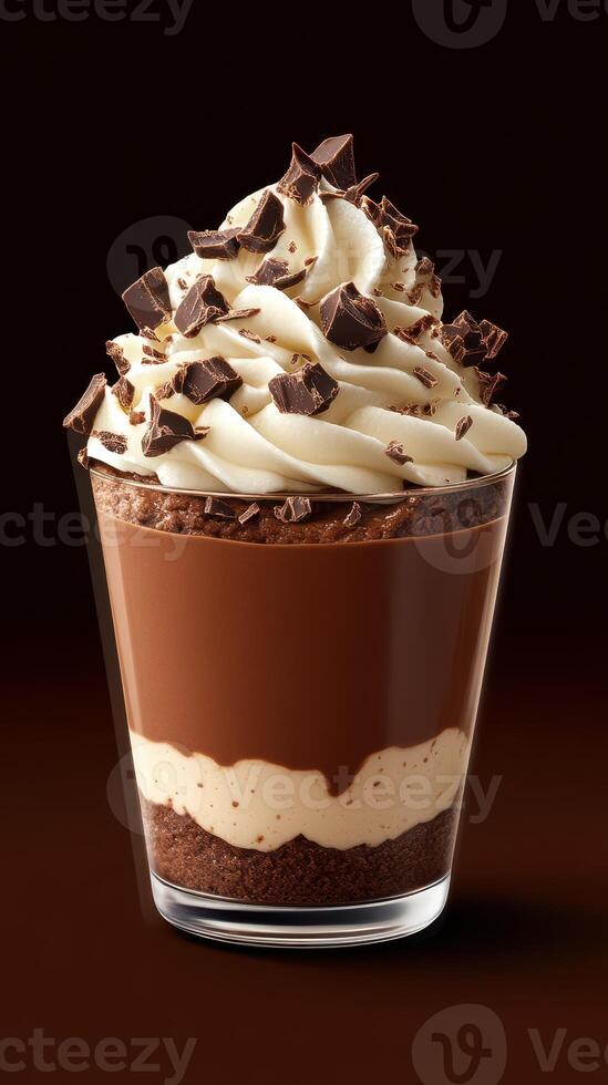 Decadent chocolate dessert displayed in a clear glass with whipped cream and chocolate shavings on top, perfect for sweet lovers photo