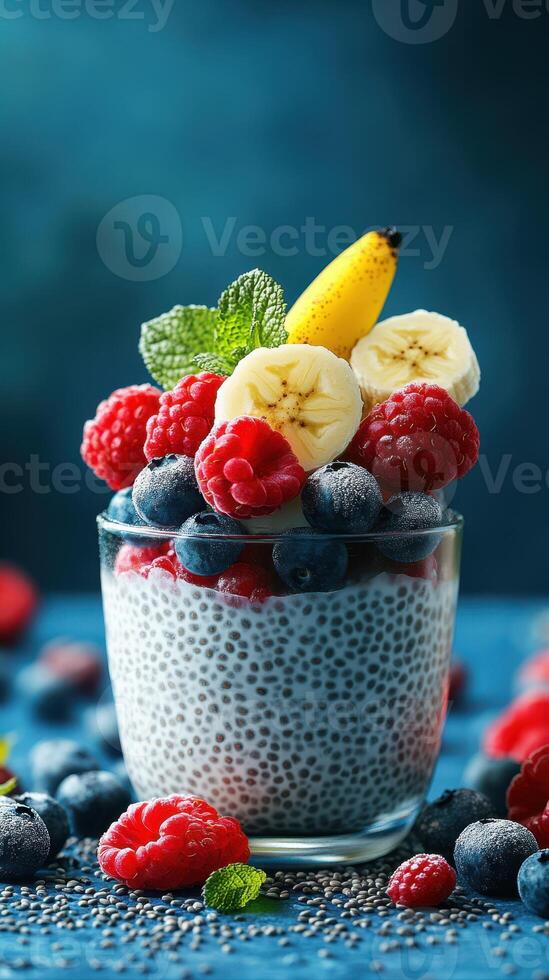 Delicious chia seed pudding topped with fresh raspberries, blueberries, and banana slices on a vibrant blue background photo