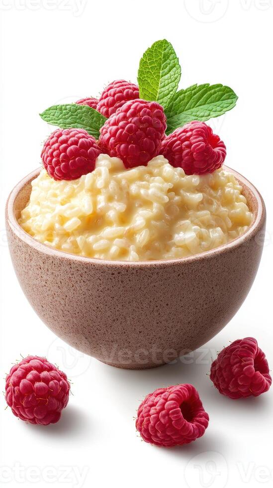 Creamy rice pudding topped with fresh raspberries and mint in a rustic bowl photo