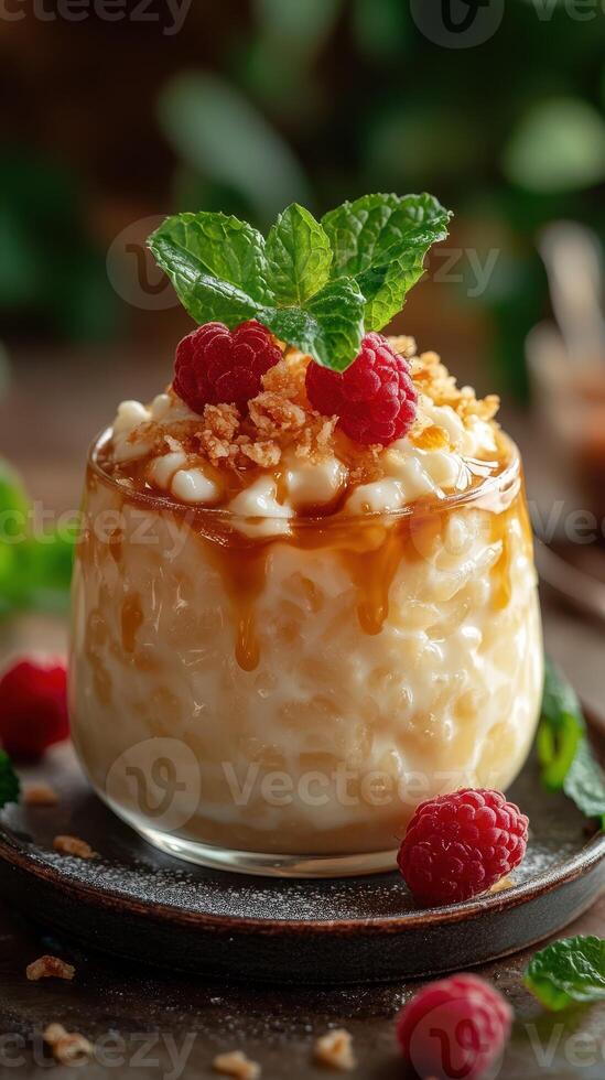 Delicious dessert featuring creamy rice pudding topped with caramel, raspberries, and mint, served on a rustic wooden table photo