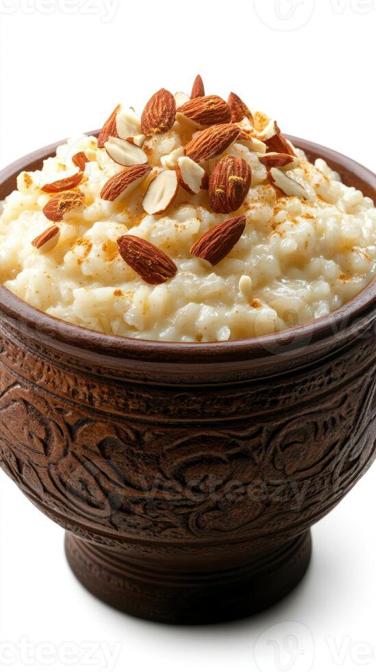 Delicious rice pudding topped with almonds and spices in a decorative bowl photo
