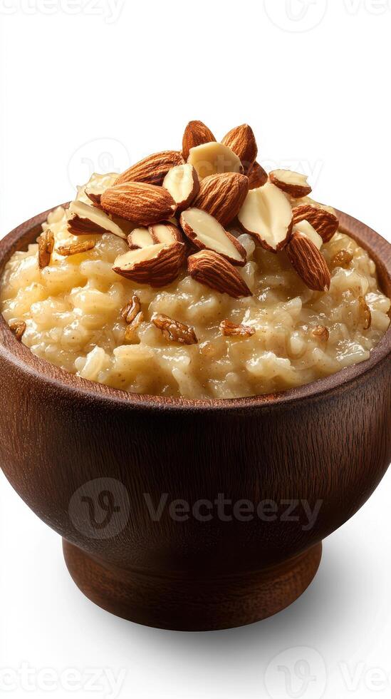 Delicious bowl of creamy rice pudding topped with almonds and a sprinkle of spices in a wooden bowl photo