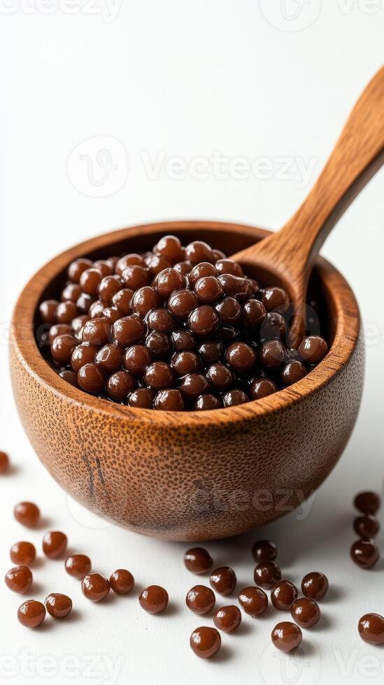 Delicious sweet tapioca pearls served in a rustic wooden bowl with a wooden spoon photo