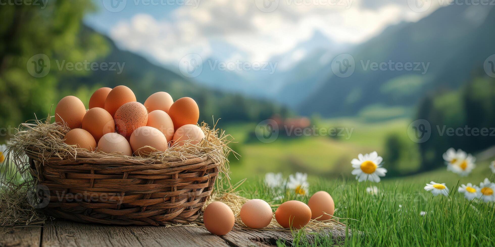 Fresh eggs in a rustic basket on a grassy meadow with mountains and wildflowers in the background photo