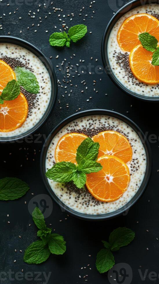 Refreshing chia seed pudding bowls topped with fresh oranges and mint at a modern kitchen setting photo