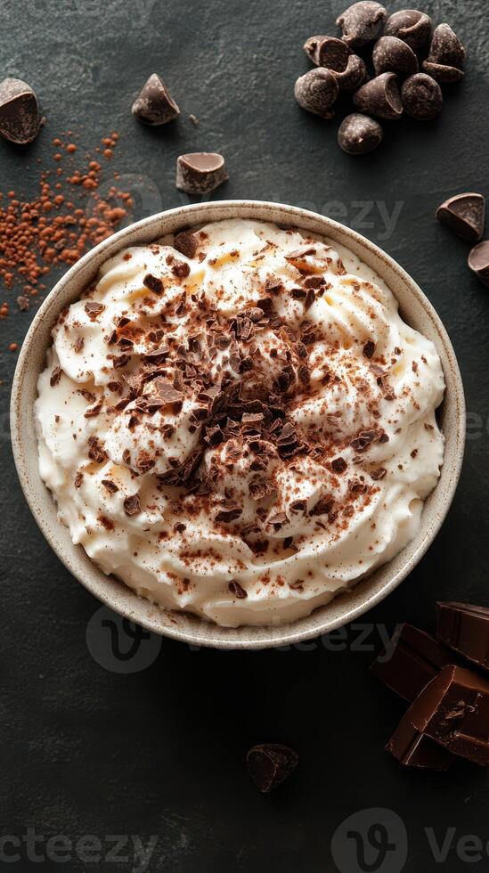 Indulging in velvety whipped cream topped with rich chocolate shavings and cocoa on a dark surface photo